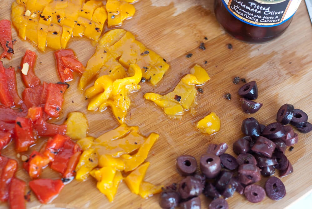 sliced roasted red and yellow peppers and olives for chickpea salad sliced roasted red and yellow peppers and olives for chickpea salad