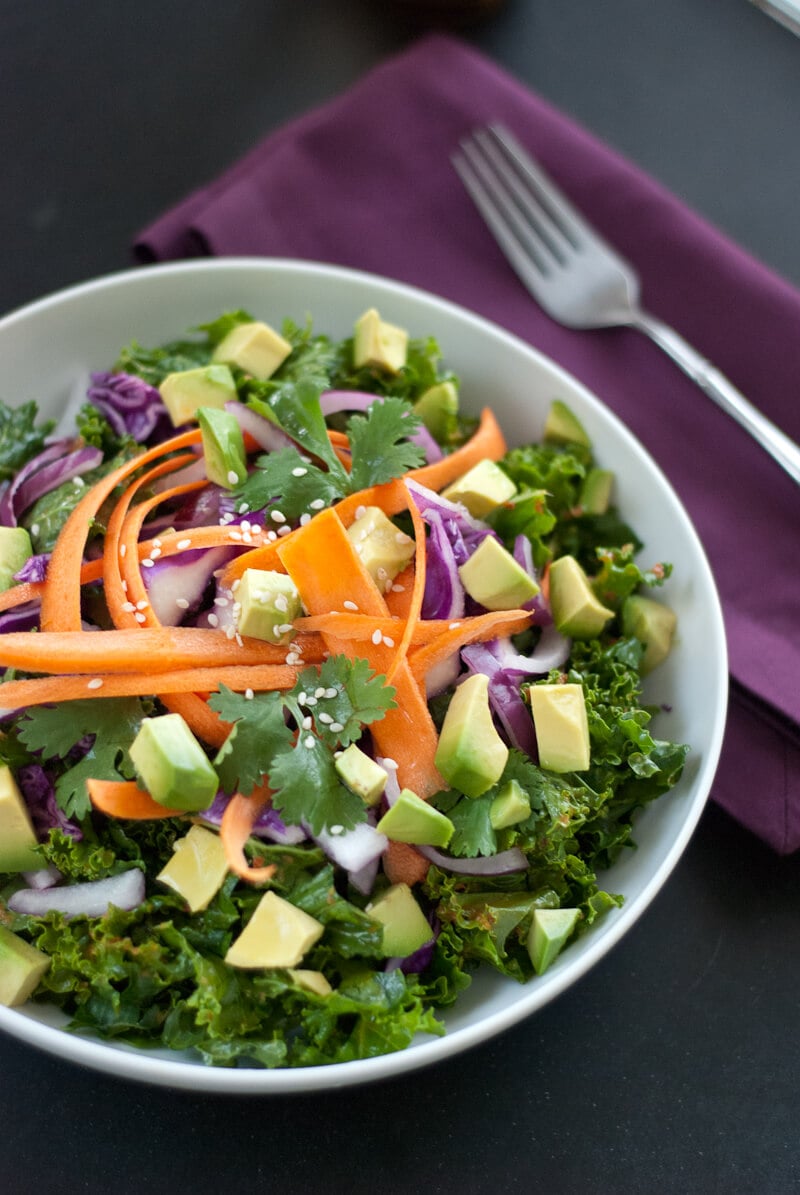 Kale salad with avocado, carrots, and ginger-red pepper dressing