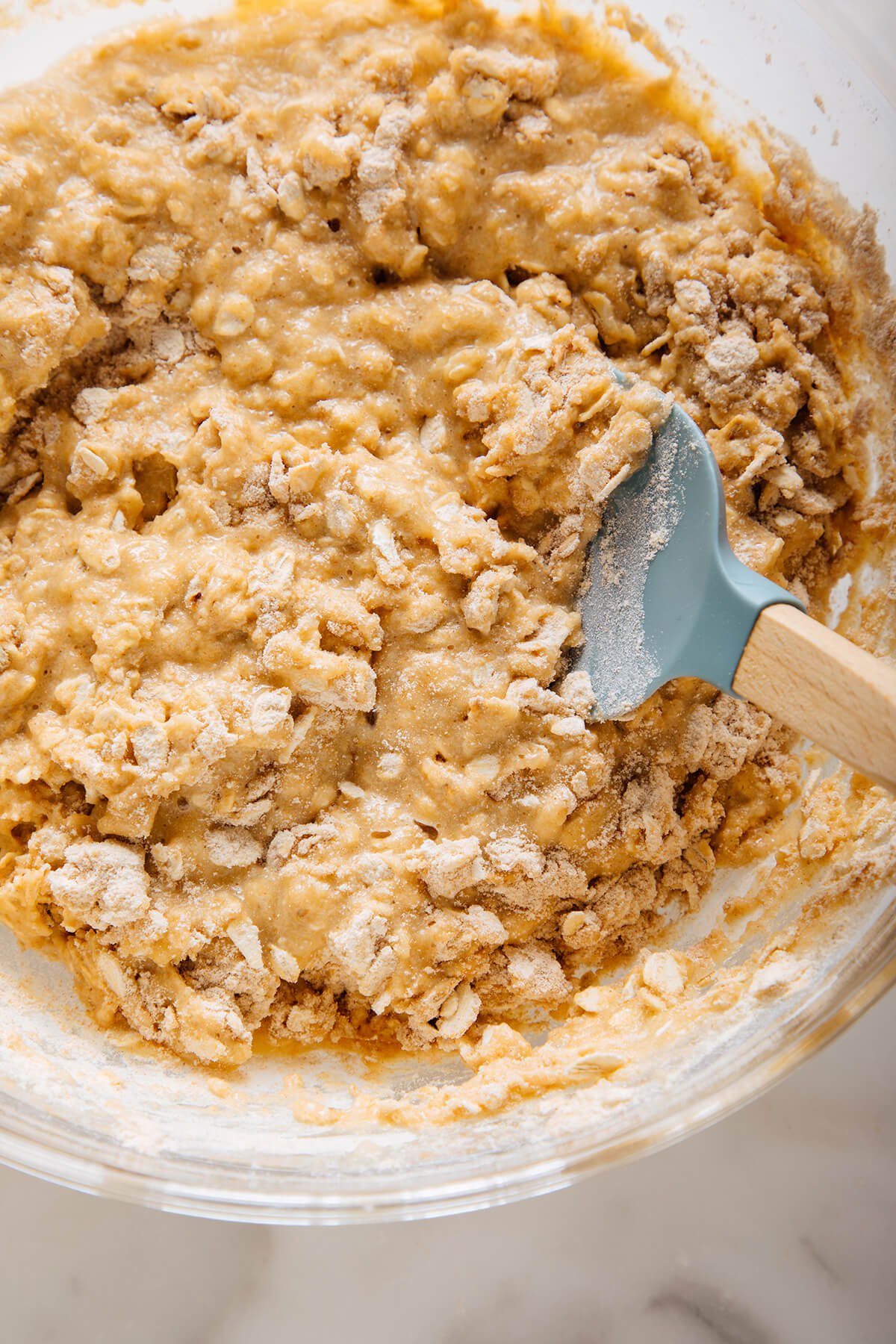 stirring apple oatmeal muffin batter