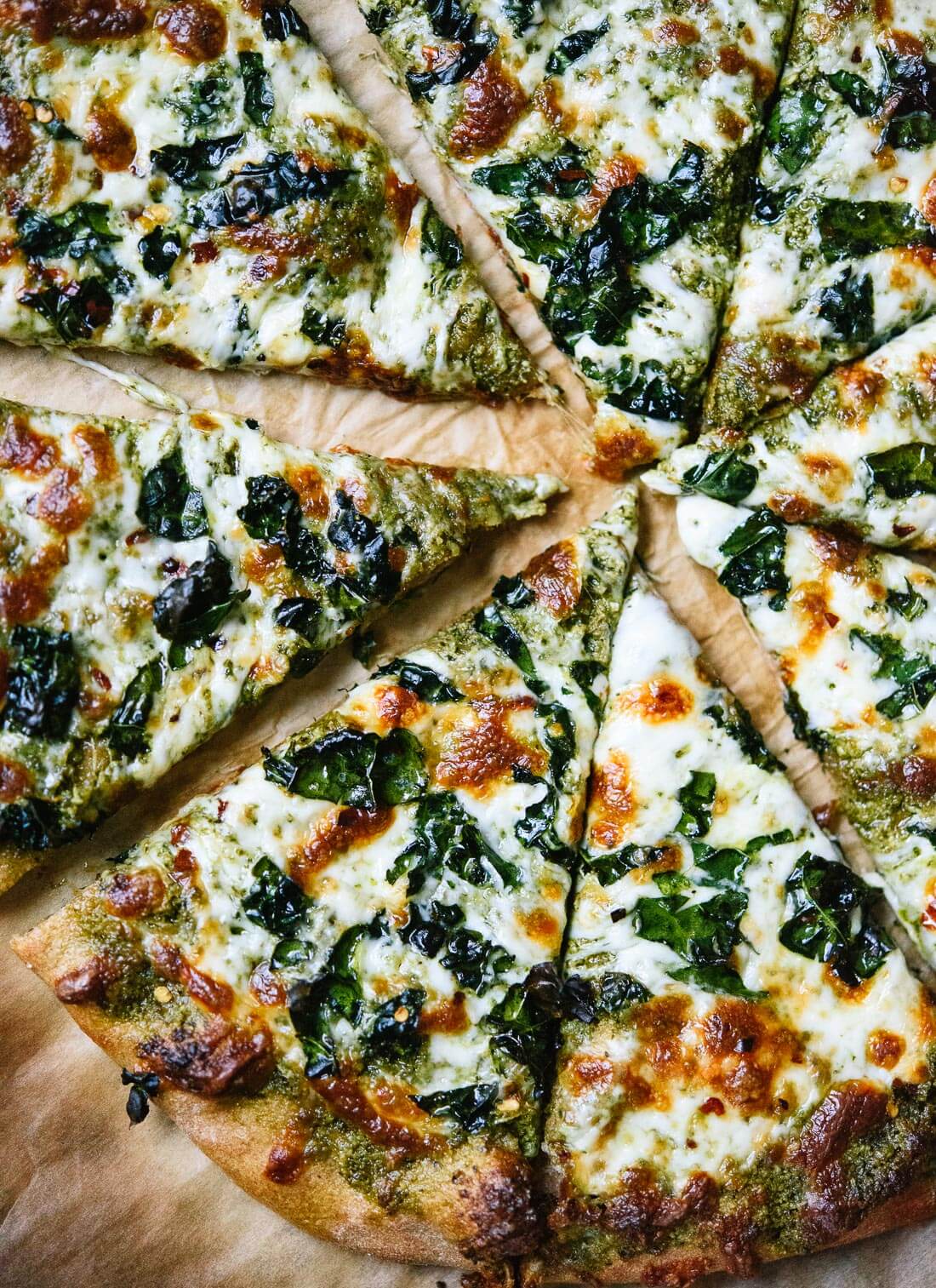 Kale pesto pizza with crispy kale on top! This is a simple weeknight pizza for kale lovers. cookieandkate.com