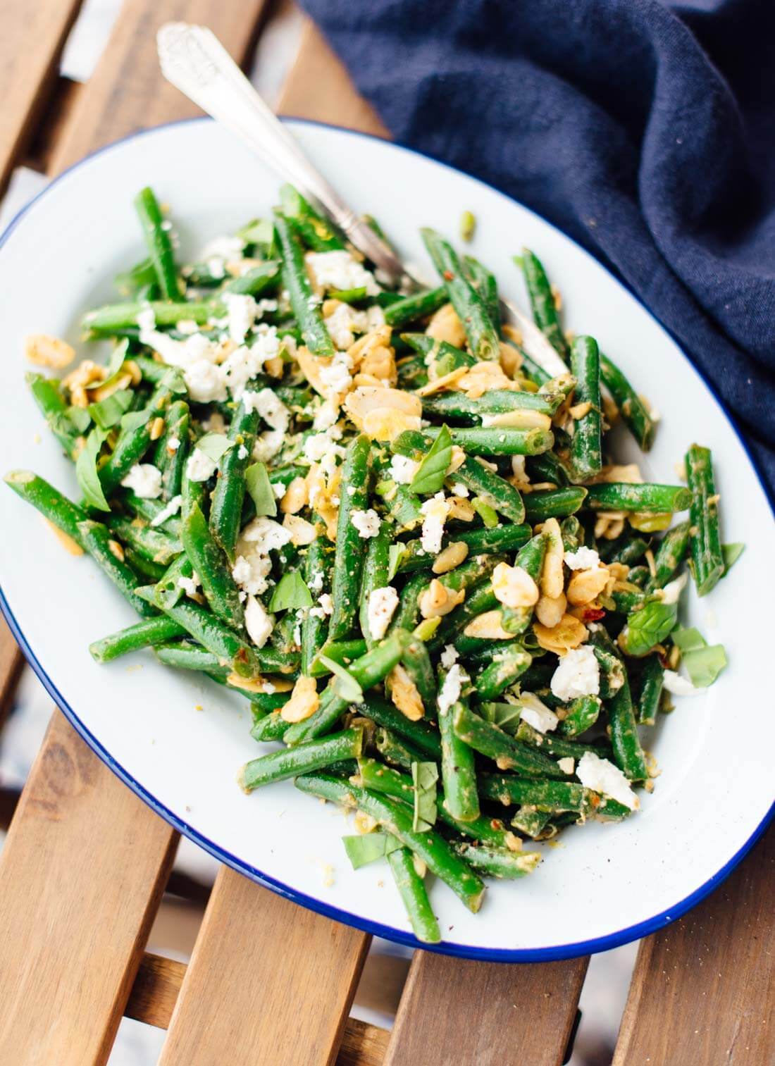 Green bean salad recipe featuring toasted almonds and feta, tossed in an irresistible lemon-garlic sauce. cookieandkate.com