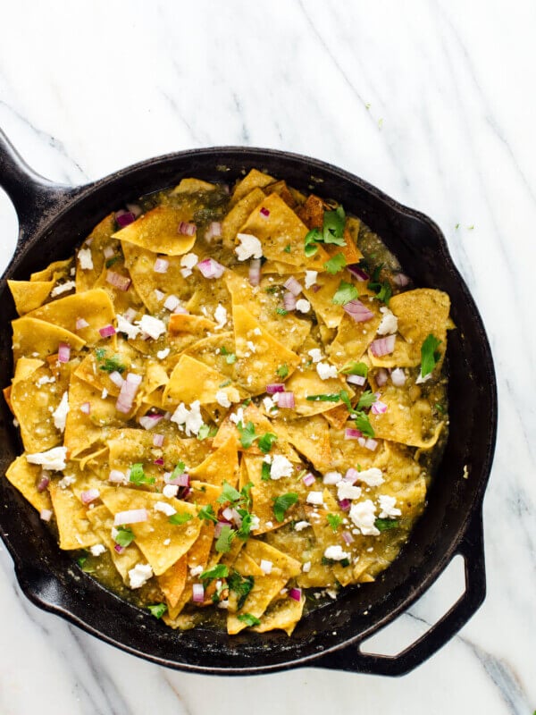 Homemade chilaquiles verdes with baked tortilla chips! Get the recipe at cookieandkate.com