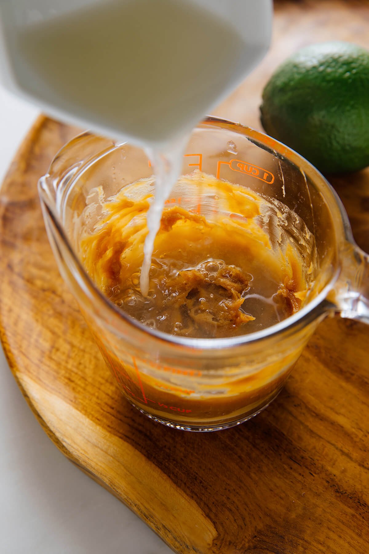 adding lime juice to peanut dressing